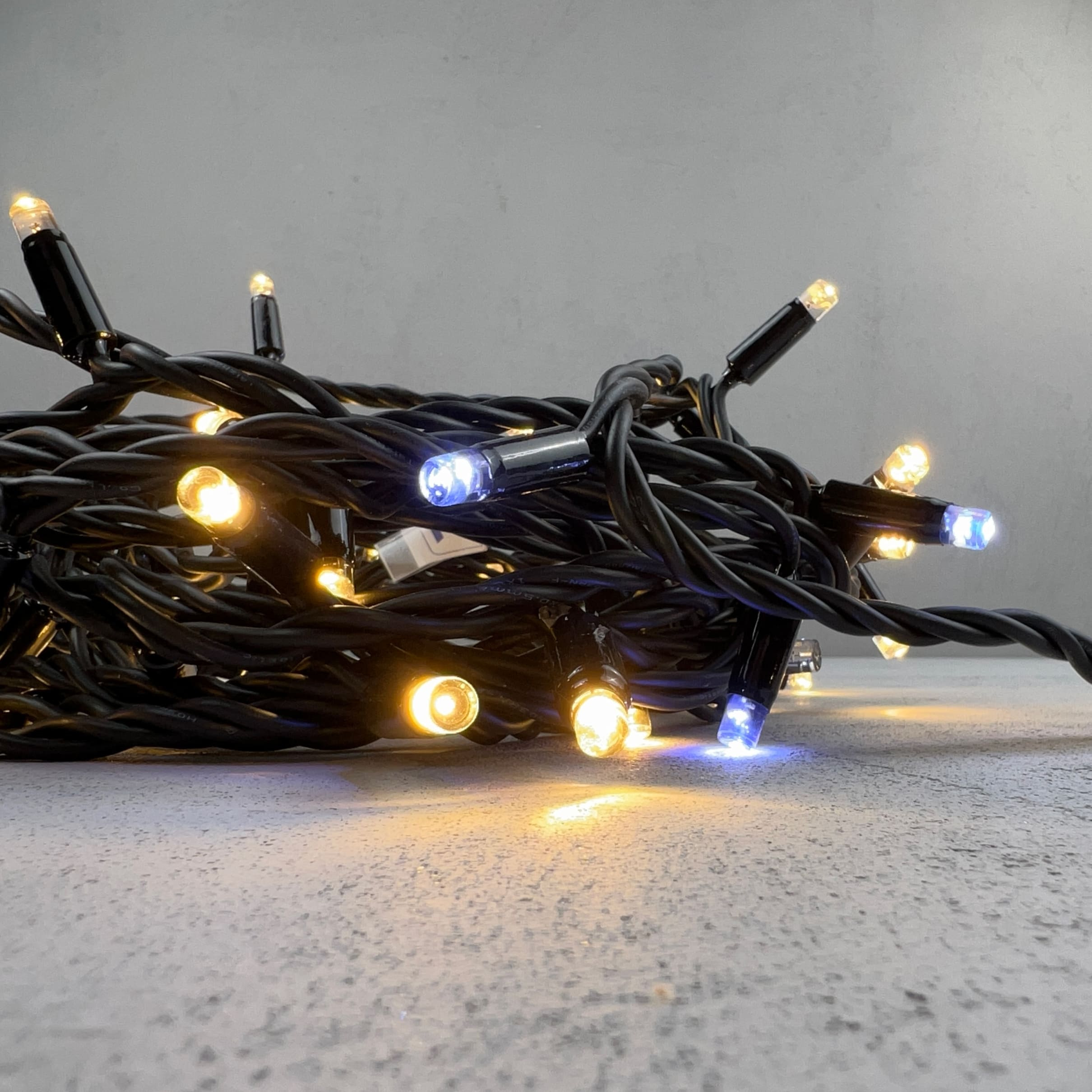 Качественная картинка Светодиодная нить с колпачком Laitcom, 10м, 24В, 75 LED, провод черный каучук, IP65, т.белый с мерц